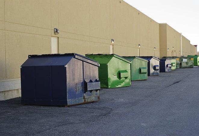 a yellow construction dumpster on a work site in Crescent Springs